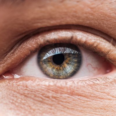 close up view of human colorful eye with eyelashes